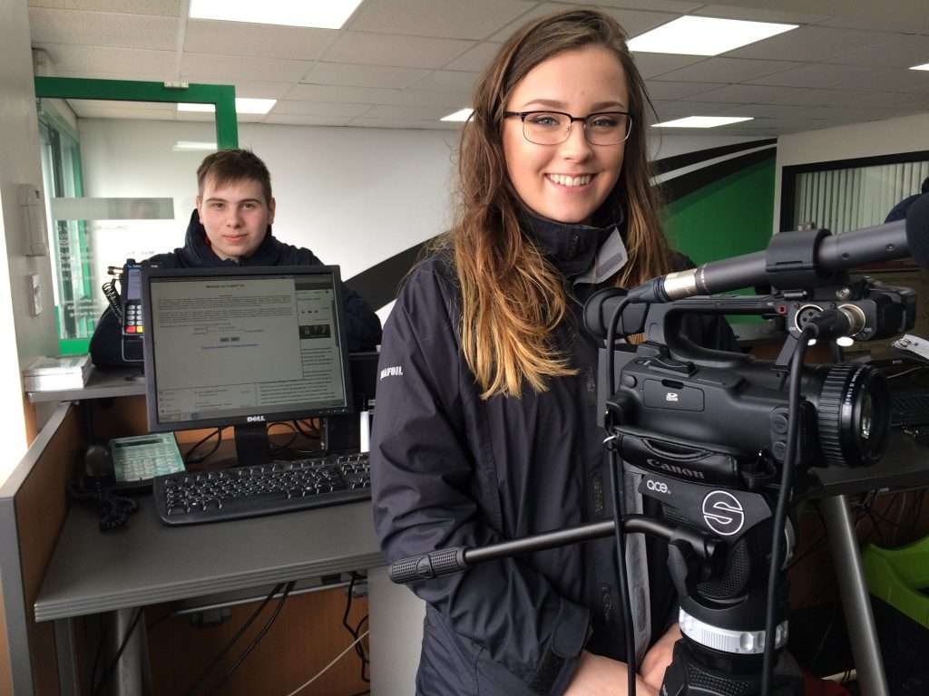young male and female with camera kit