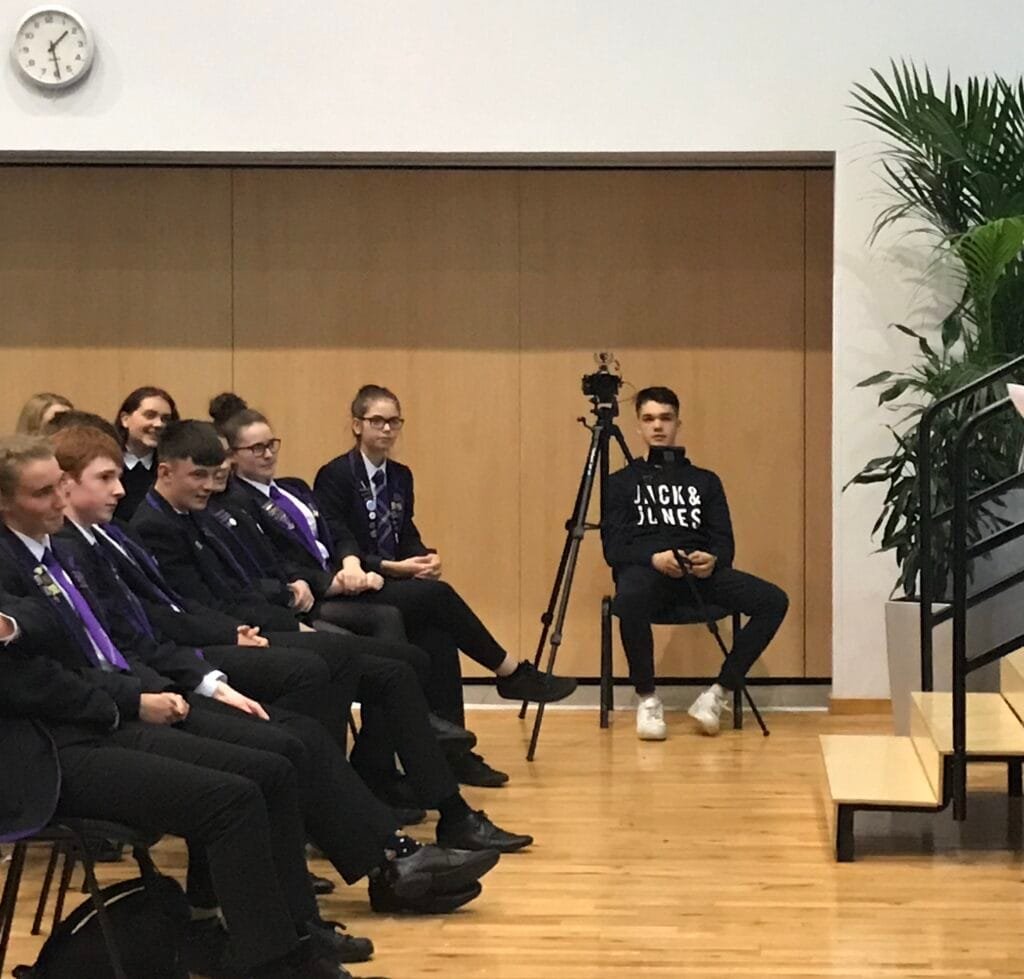 group of young adults seated in a room